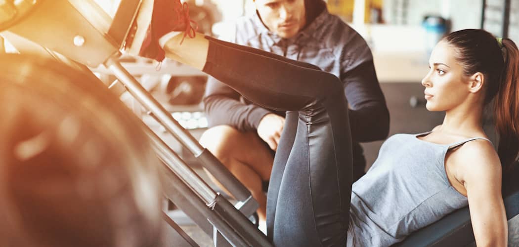 woman using a leg press for glutes