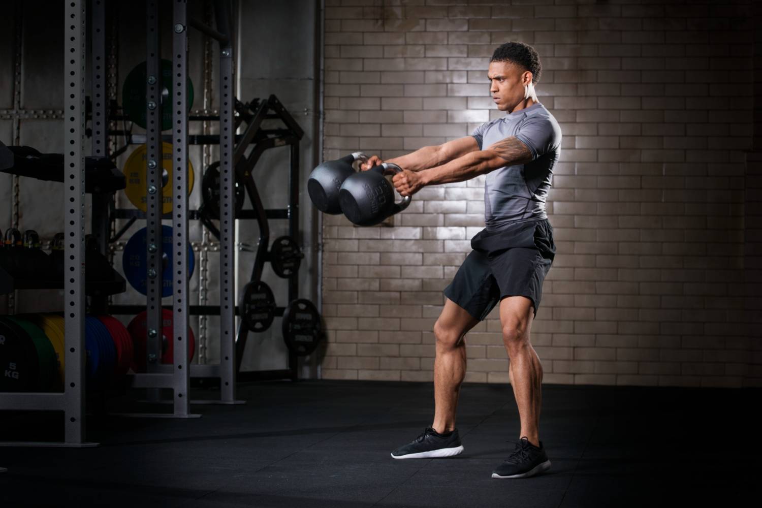 A man swinging competition kettlebells