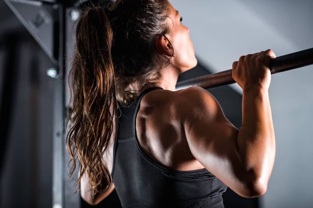 A woman performing an indoor chin up