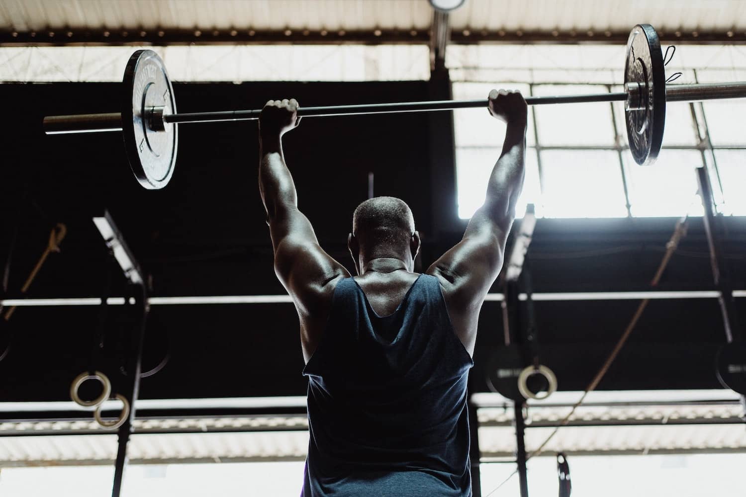 A man in a gym lifting a barbell